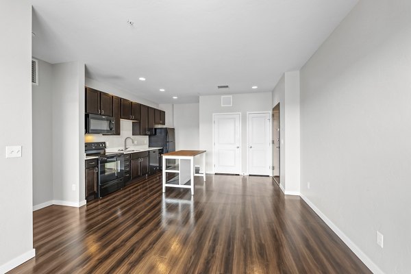 Modern living room with plush seating and natural light at Confluence at Three Springs Apartments