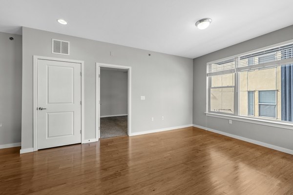 Spacious living room with modern furnishings at Confluence at Three Springs Apartments