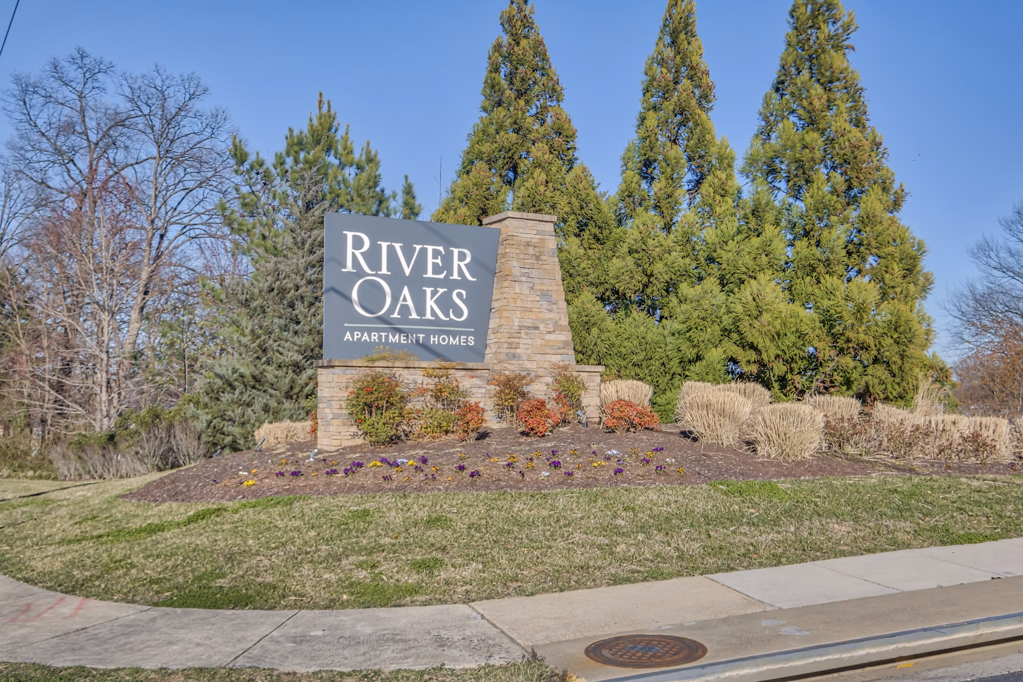 River Oaks Apartments: Distinctive signage at luxury property in serene neighborhood