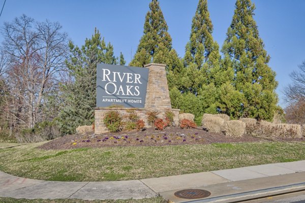 River Oaks Apartments: Distinctive signage at luxury property in serene neighborhood