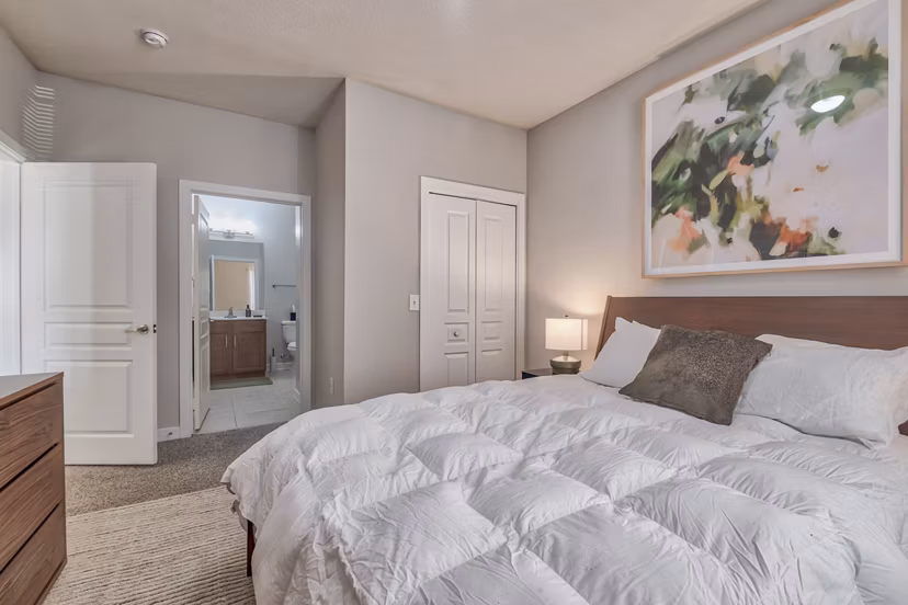Cozy bedroom featuring modern decor and natural light in River Oaks Apartments