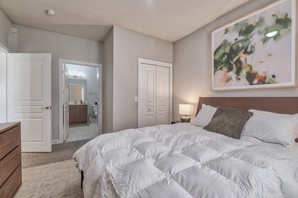 Cozy bedroom featuring modern decor and natural light in River Oaks Apartments