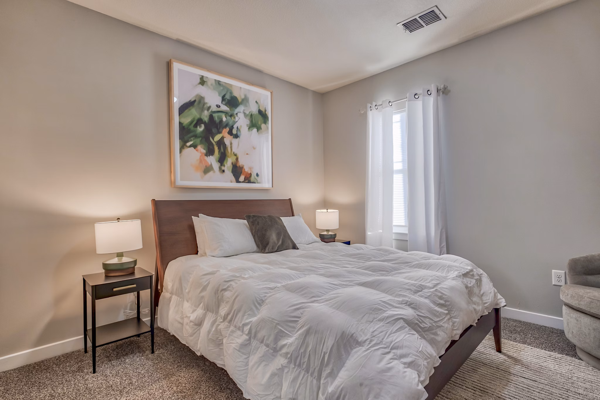 Chic bedroom with large windows and modern decor in River Oaks Apartments