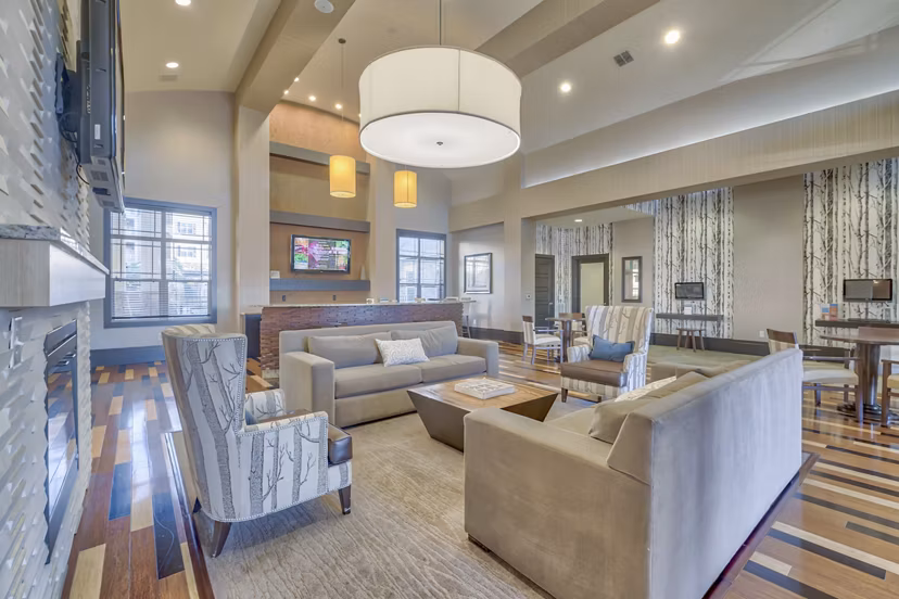 Clubhouse with modern furnishings and pool table at River Oaks Apartments luxury apartments in Woodbridge, VA.