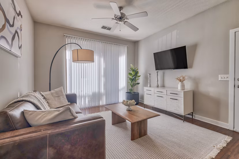 Spacious living room with elegant furnishings in River Oaks Apartments luxury residences