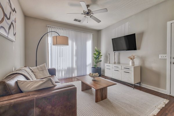 Spacious living room with elegant furnishings in River Oaks Apartments luxury residences