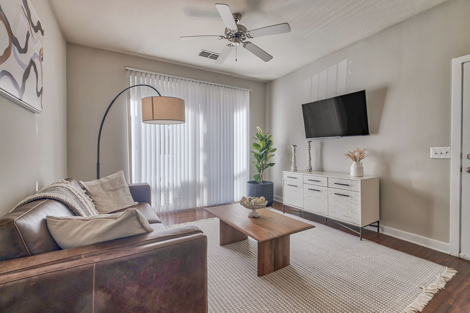 Spacious living room with elegant furnishings in River Oaks Apartments luxury residences