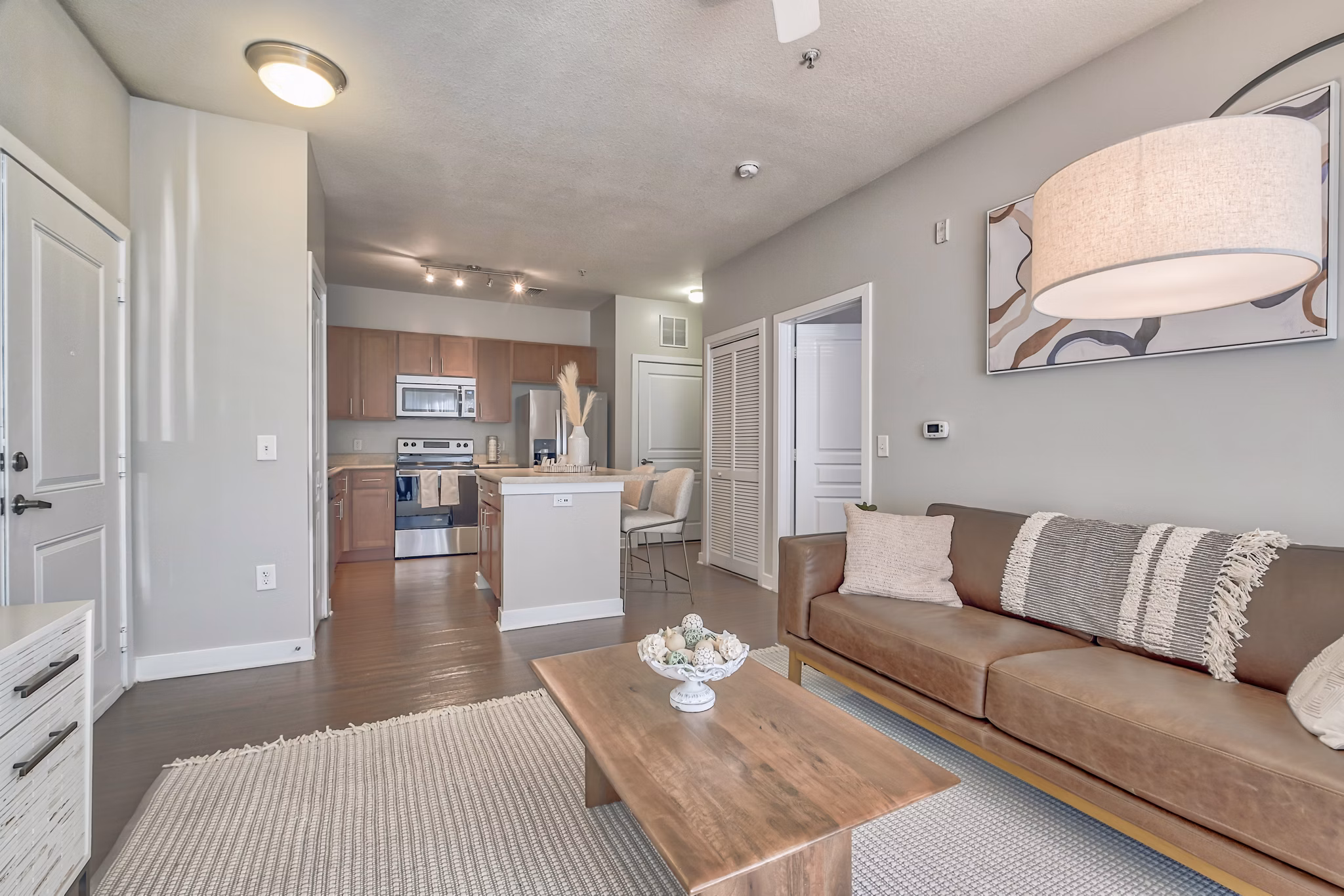 Living room with contemporary design at River Oaks Apartments, featuring luxury furnishings and ample natural light