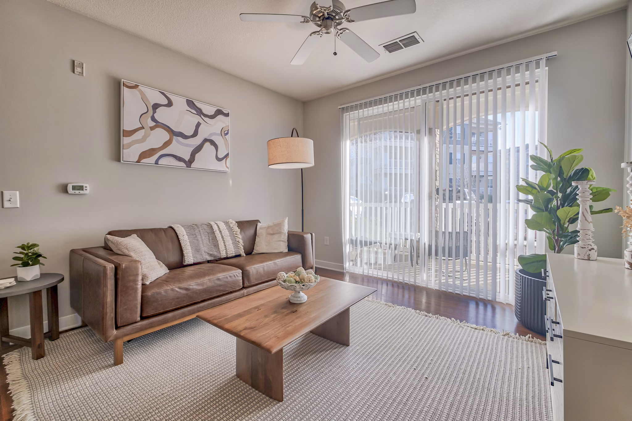 Spacious living room with modern design and natural light in River Oaks Apartments, a luxury residence by Greystar