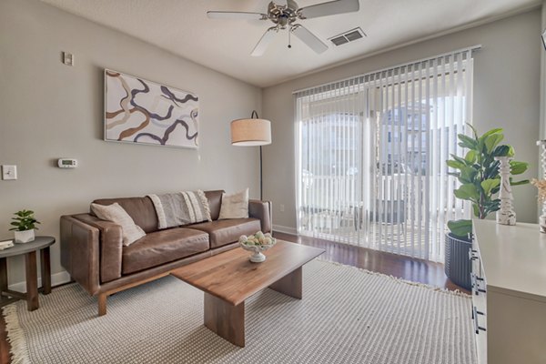 Spacious living room with modern design and natural light in River Oaks Apartments, a luxury residence by Greystar
