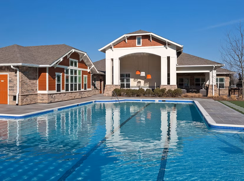 Luxurious pool with lounge seating at River Oaks Apartments, offering a relaxing retreat for residents