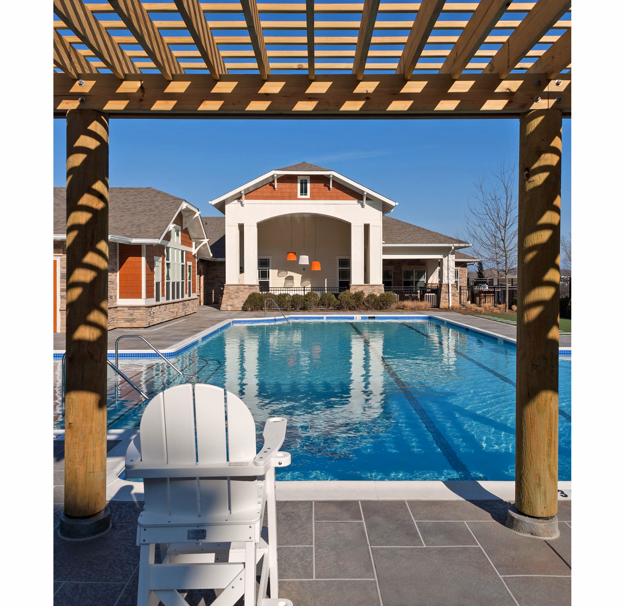 Pool with lounge chairs at River Oaks Apartments offers a relaxing retreat