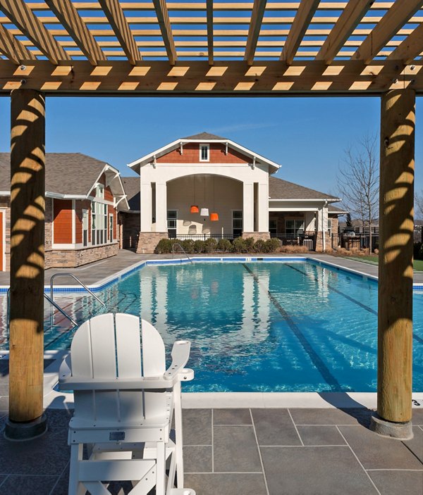 Pool with lounge chairs at River Oaks Apartments offers a relaxing retreat