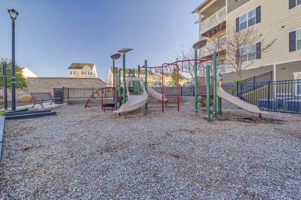 Colorful playground with slides and swings at River Oaks Apartments, perfect for family fun and outdoor activities