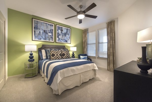 Cozy bedroom with elegant furnishings at Eastbank at Waterside Apartments