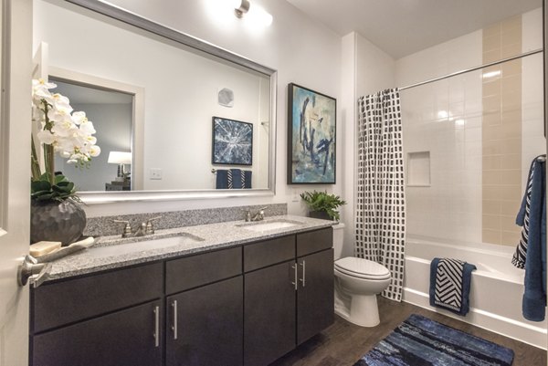 Bathroom with modern fixtures and sleek vanity at Eastbank at Waterside Apartments, offering a luxurious living experience