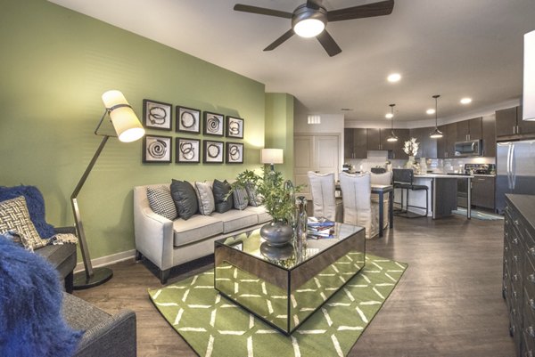 Spacious living room with modern decor at Eastbank at Waterside Apartments, featuring elegant furnishings and ample natural light