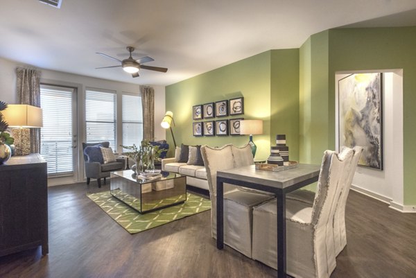 Spacious living room featuring modern decor and large windows in Eastbank at Waterside Apartments