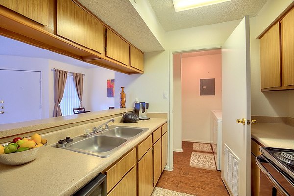 Modern kitchen with stainless steel appliances at Arrowhead Pointe Apartments