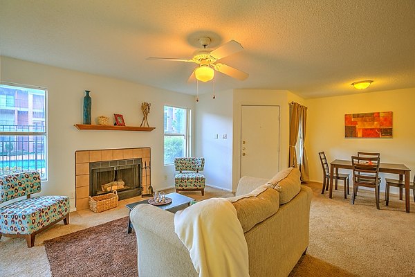 Spacious living room with modern furnishings at Arrowhead Pointe Apartments in Greystar community