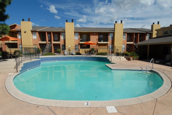 Outdoor pool with resort-style seating at Arrowhead Pointe Apartments