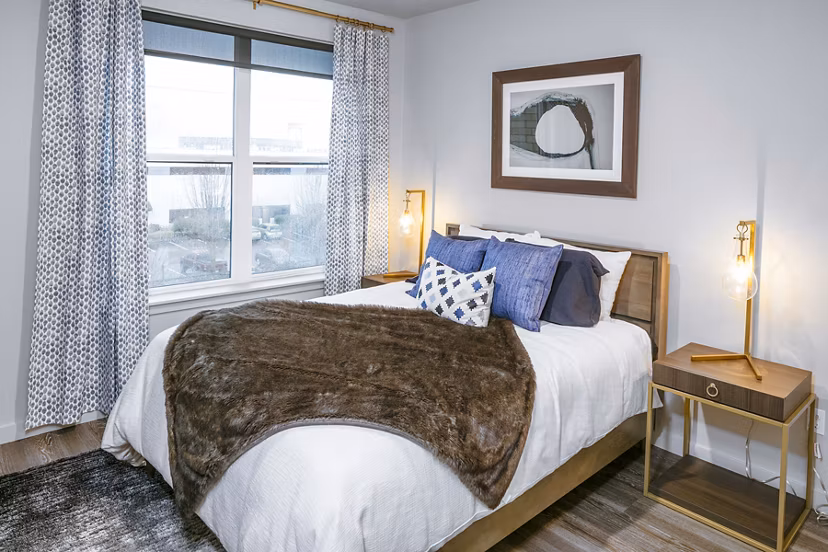 Cozy bedroom with modern furnishings at Waterline Apartments, offering luxurious living spaces in a Greystar luxury community