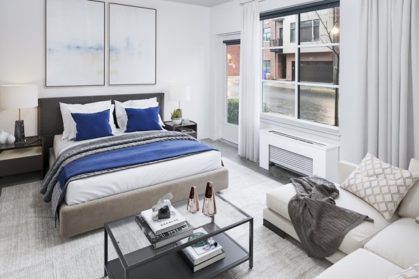 Tranquil bedroom with modern furnishings at Waterline Apartments, featuring floor-to-ceiling windows for natural light
