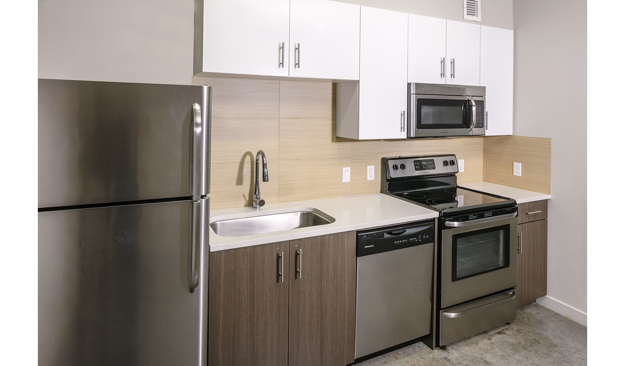 Modern kitchen with sleek finishes and stainless steel appliances at Waterline Apartments