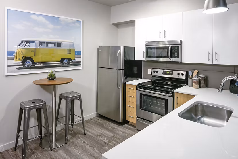 Kitchens with modern appliances and sleek countertops in Waterline Apartments