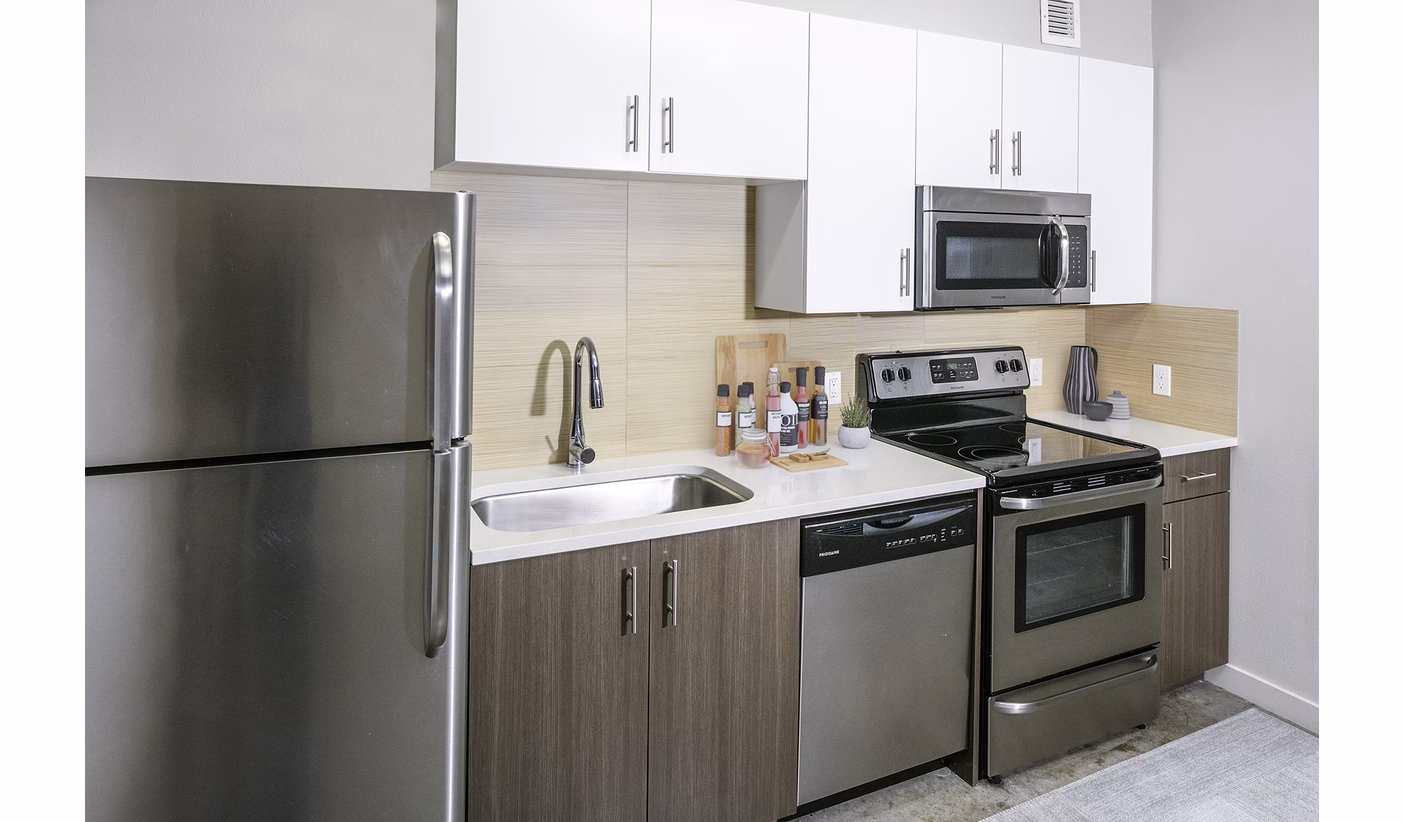 Modern kitchen featuring stainless steel appliances at Waterline Apartments