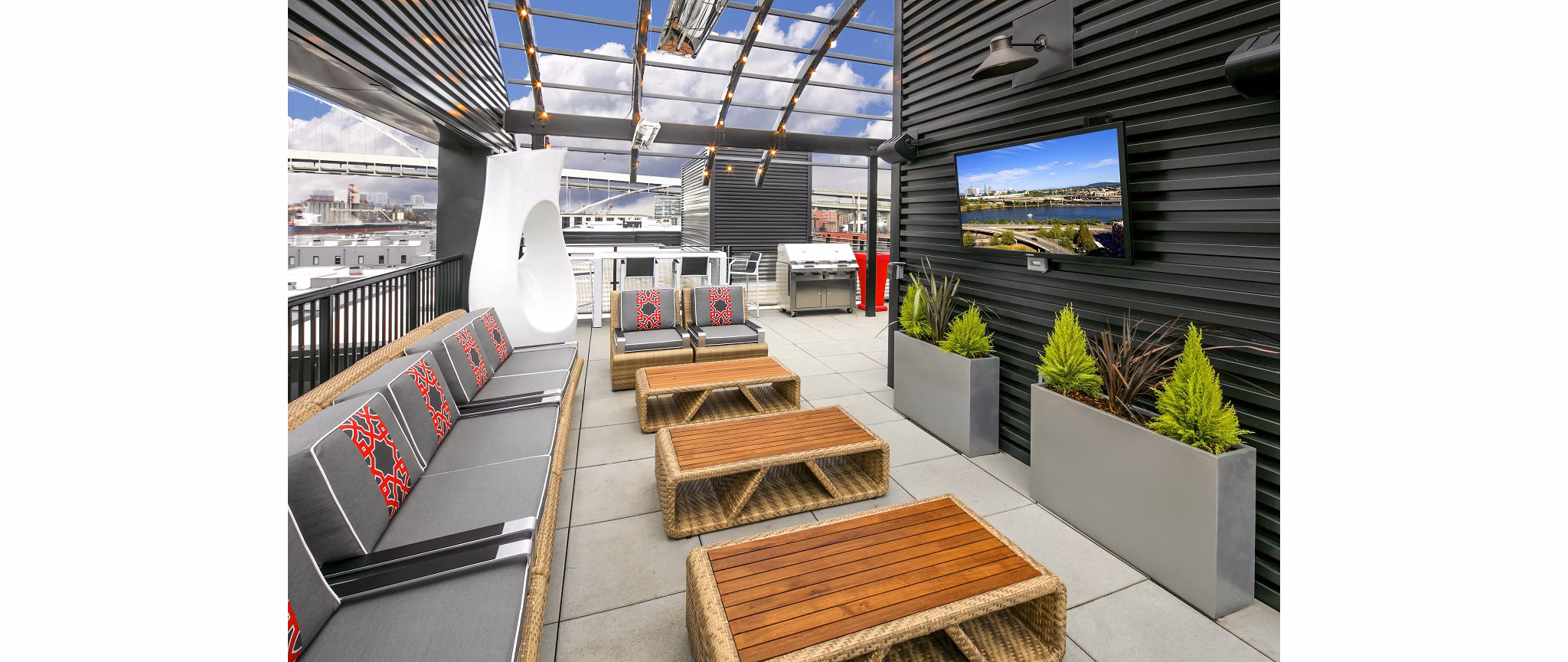Cozy patio with seating and potted plants at Waterline Apartments offering luxury Greystar living