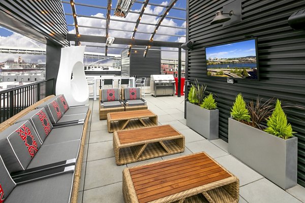 Cozy patio with seating and potted plants at Waterline Apartments offering luxury Greystar living