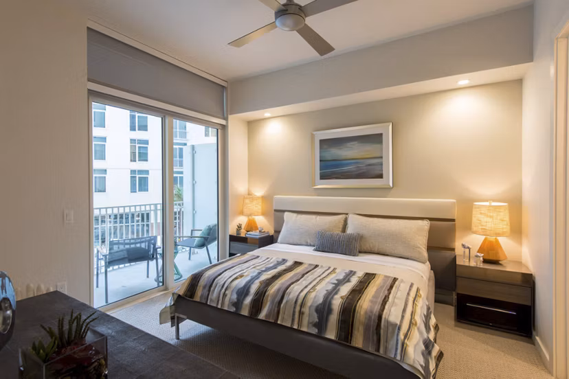 Luxurious bedroom with designer furnishings at One Hermann Place Apartments