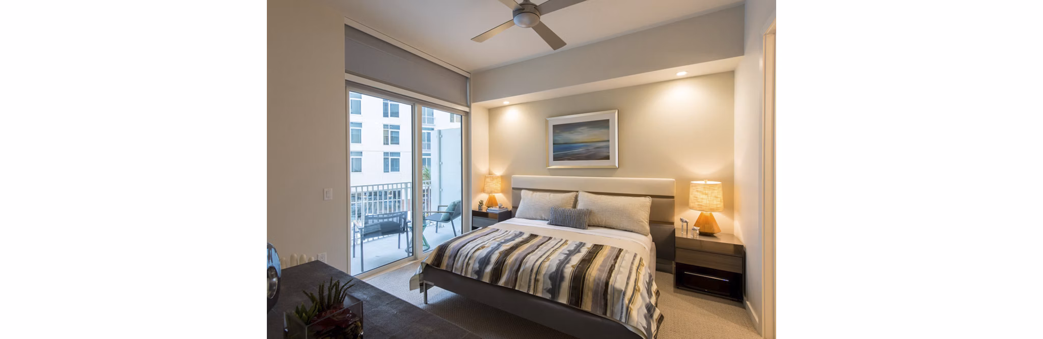 Luxurious bedroom with designer furnishings at One Hermann Place Apartments