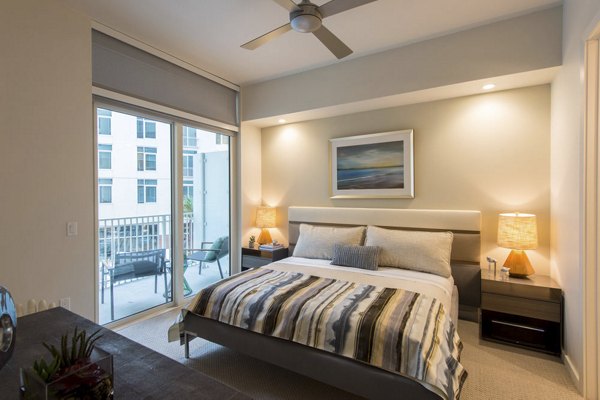 Luxurious bedroom with designer furnishings at One Hermann Place Apartments