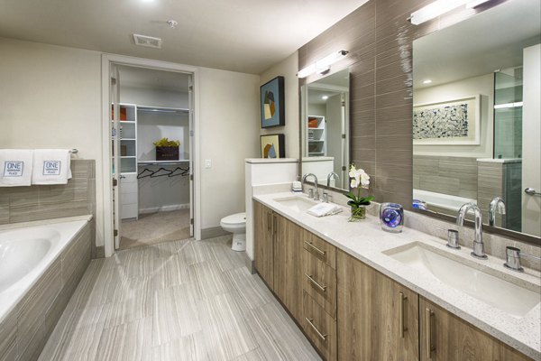 Modern bathroom with sleek fixtures at One Hermann Place Apartments, Houston's luxury living community