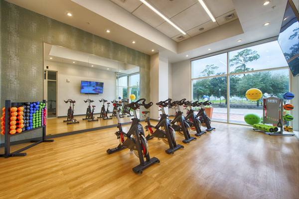 fitness center at One Hermann Place Apartments