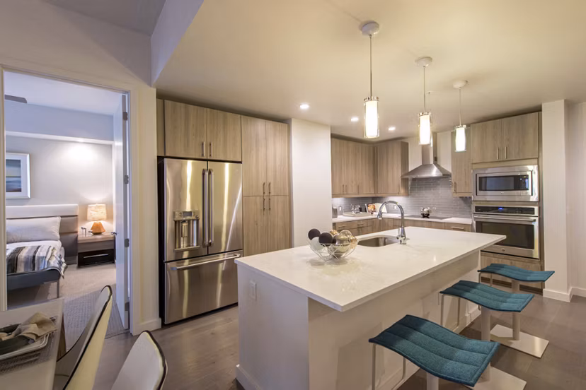 Modern kitchen with stainless steel appliances at One Hermann Place Apartments