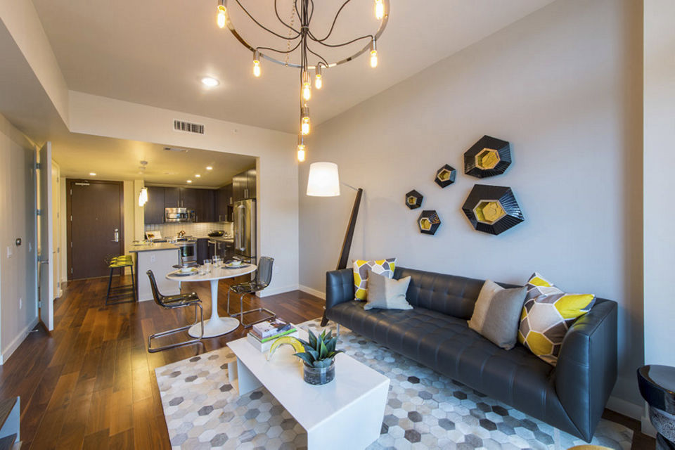 Spacious living room with modern decor at One Hermann Place Apartments