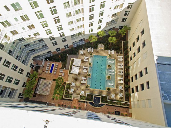 Resort-style pool with lounge chairs at One Hermann Place Apartments, luxury living in Houston