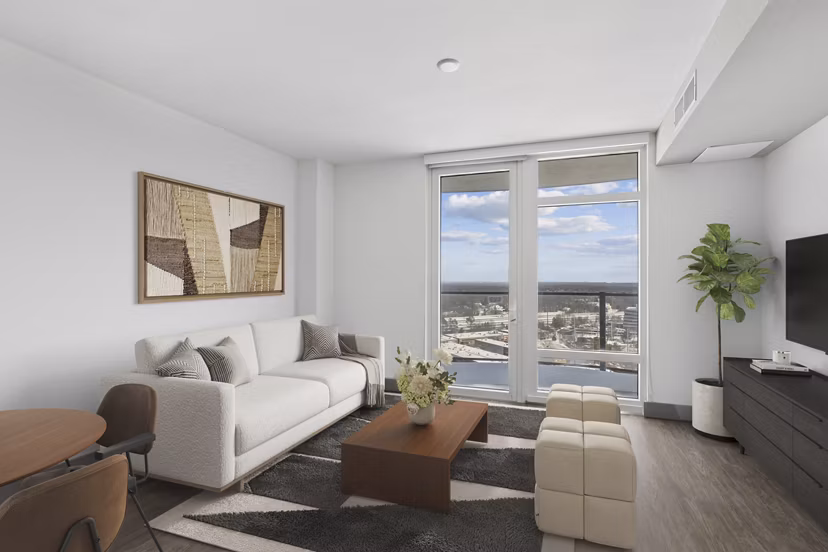 Spacious living room with contemporary decor and natural light at Adaire Apartments