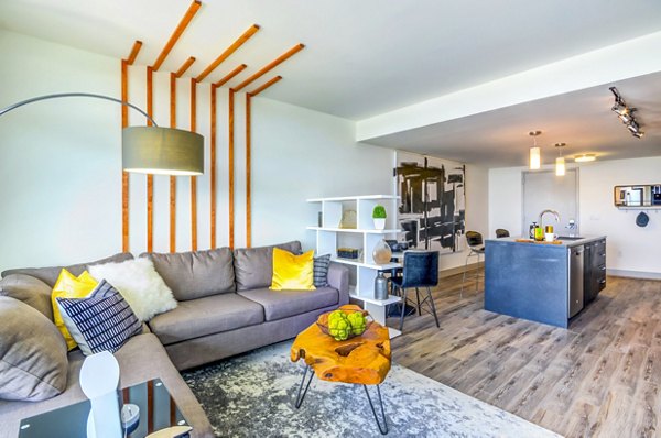 Spacious living room with contemporary decor and natural light at Adaire Apartments