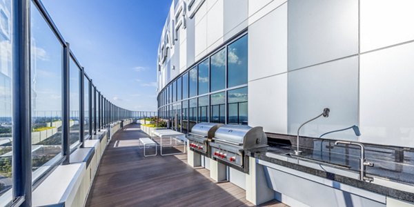 Grill area with modern patio seating at Adaire Apartments, perfect for outdoor entertaining in a luxury setting
