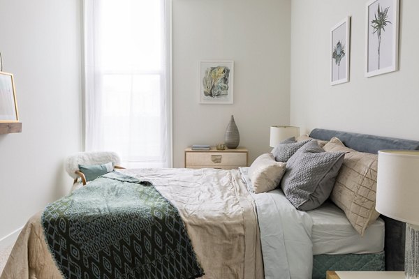 Cozy bedroom with modern furnishings at The Pennsylvanian Apartments