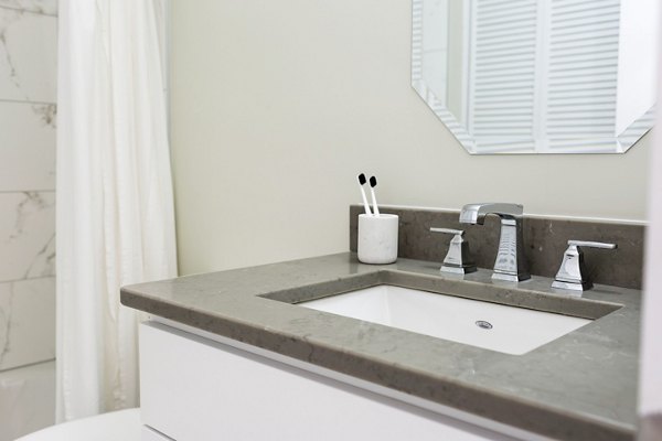 Luxurious bathroom with modern fixtures at The Pennsylvanian Apartments, a Greystar community