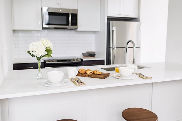 Modern kitchen with stainless steel appliances at The Pennsylvanian Apartments