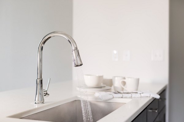 Kitchen with modern appliances and granite countertops at The Pennsylvanian Apartments