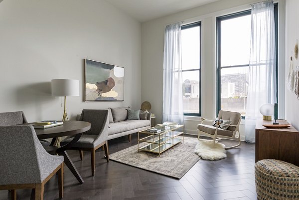 Spacious living room with modern decor in The Pennsylvanian Apartments