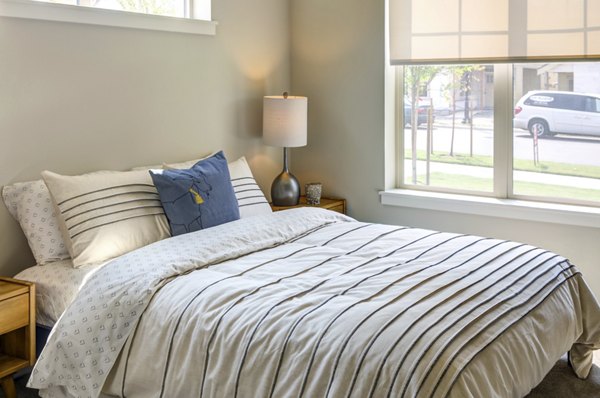 Cozy bedroom with large windows and modern decor in North Bethany Ridge Apartments