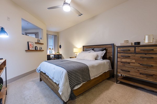 Elegant bedroom featuring modern decor at The Gramercy Apartments with serene ambiance and stylish furnishings for a luxurious living experience